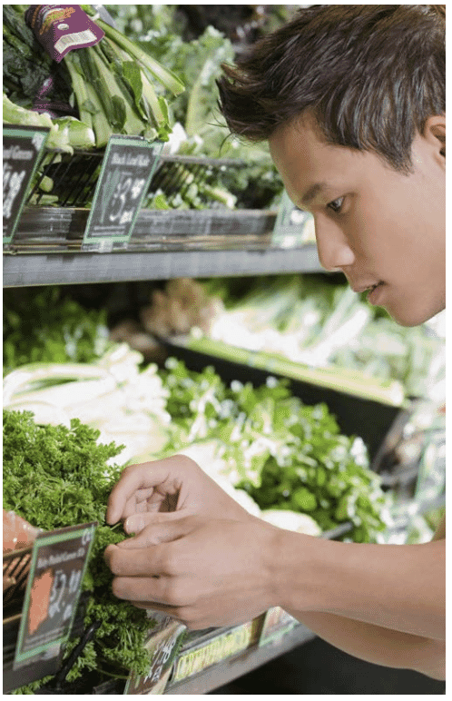Supermarket staff checking items on shelf